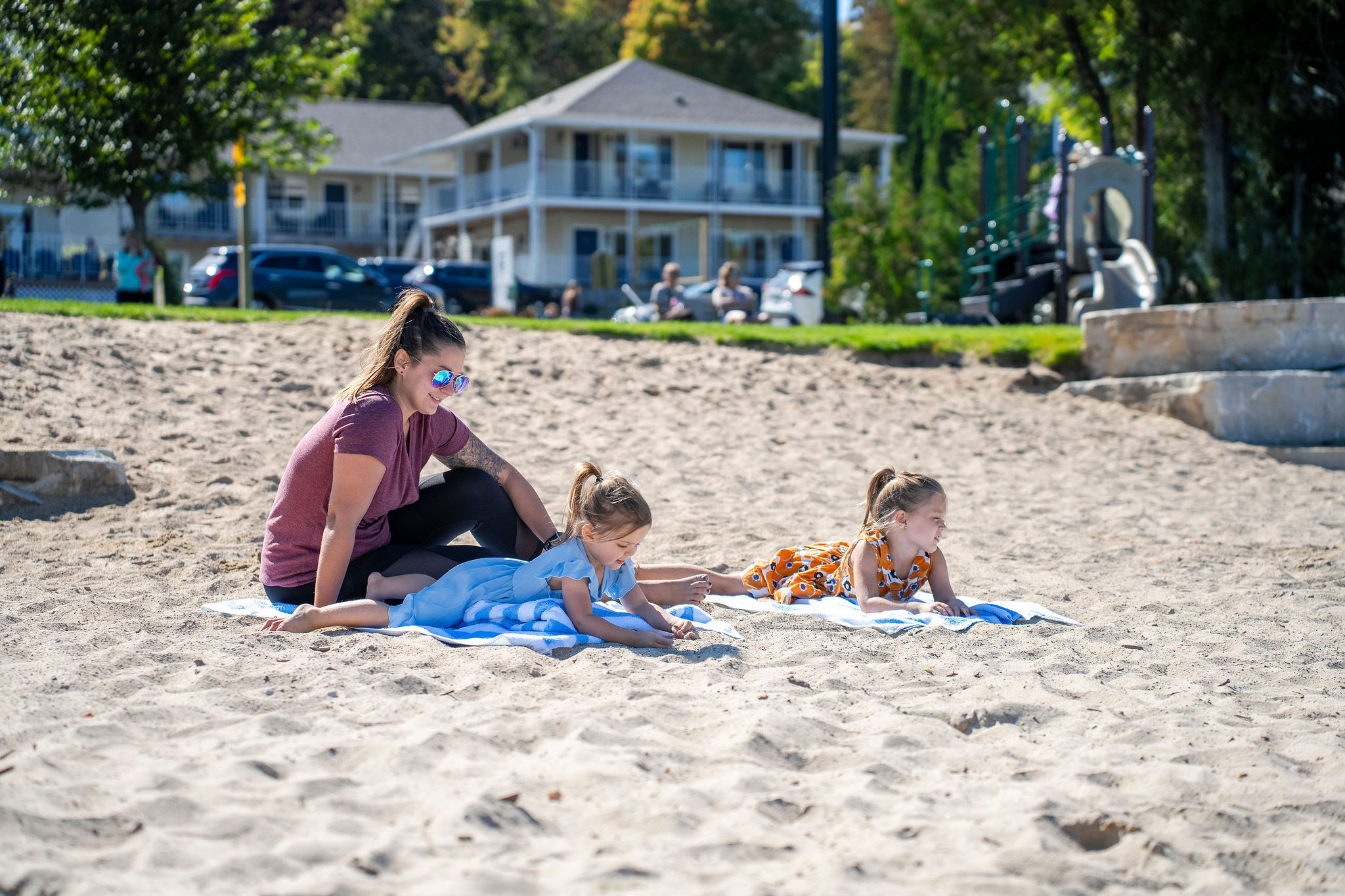 Family relaxing on sunny beach day.