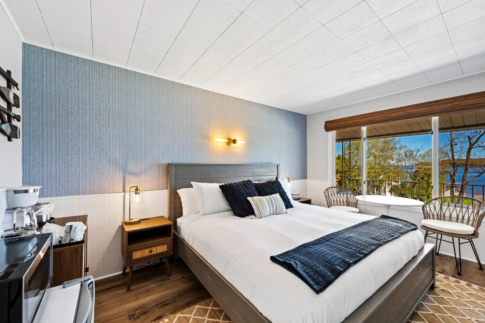 Modern bedroom with lake view and cozy decor.