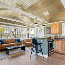 Cozy living room with modern kitchen and seating.