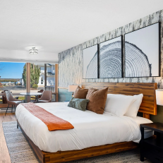Modern hotel room with sea view and decor.